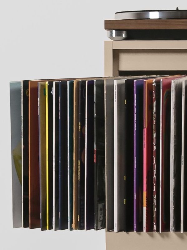The Bloom Kit fitted into a cabinet, its grey felt sleeves fanned open full of records, a turntable above — Groovaly