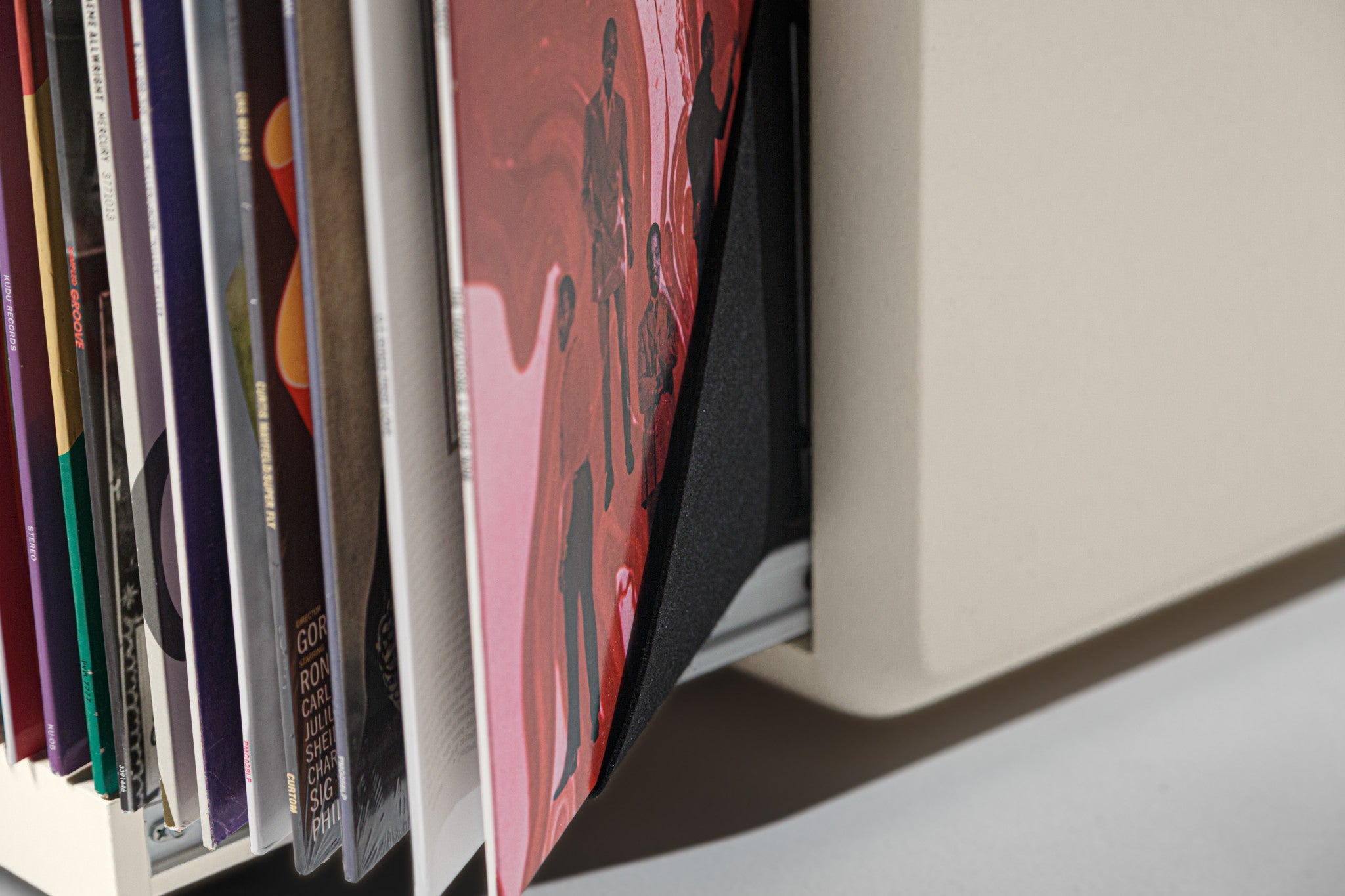Close view of the Bloom drawer fanned open, record covers shown across the felt sleeves — Groovaly