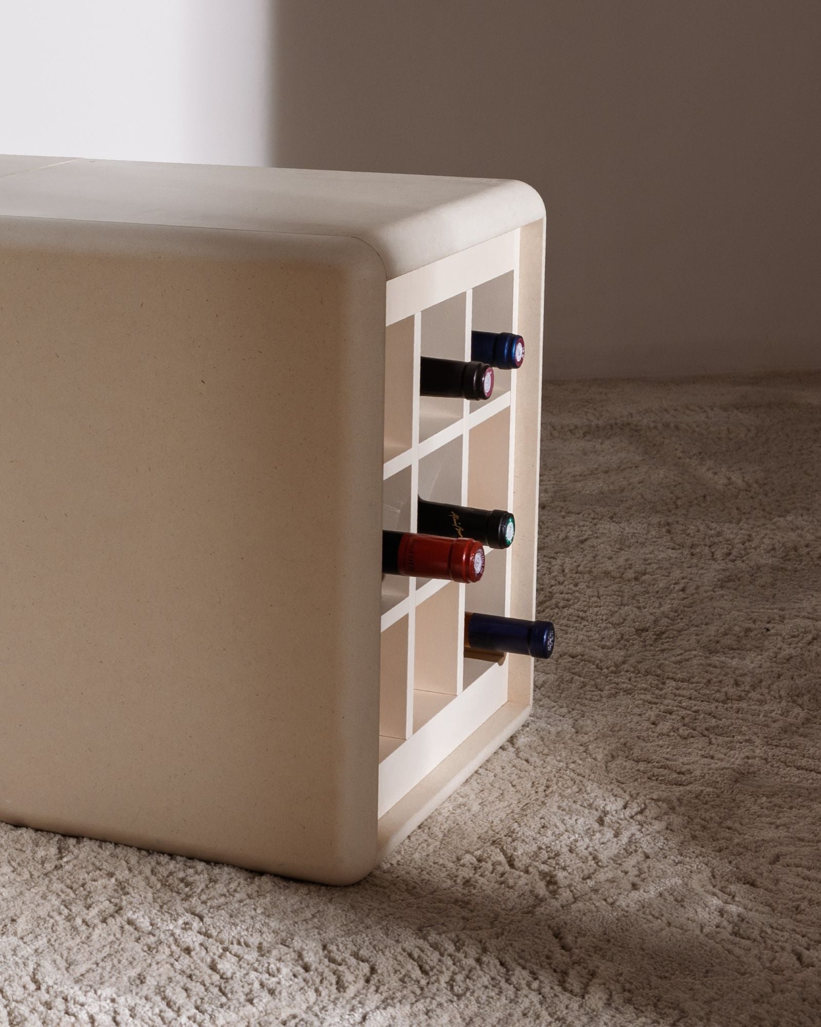 Grid wine module in White Pearl on the floor, bottles resting in the compartments with their necks out — Groovaly
