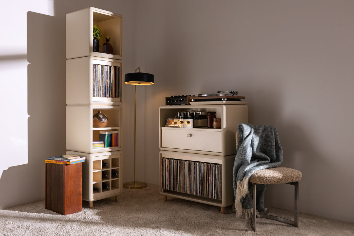 A Golden Age setup in White Pearl: the Lou tower and Maceo, records and turntable in a warm living room — Groovaly