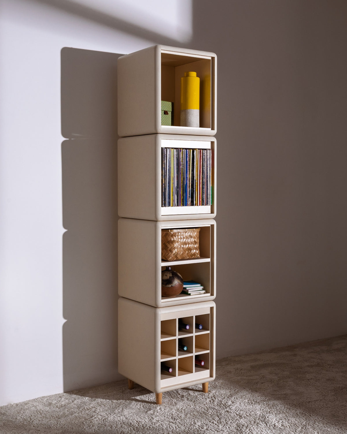 Lou in White Pearl at an angle, a styled four-module tower with records, objects and bottles in the Grid — Groovaly