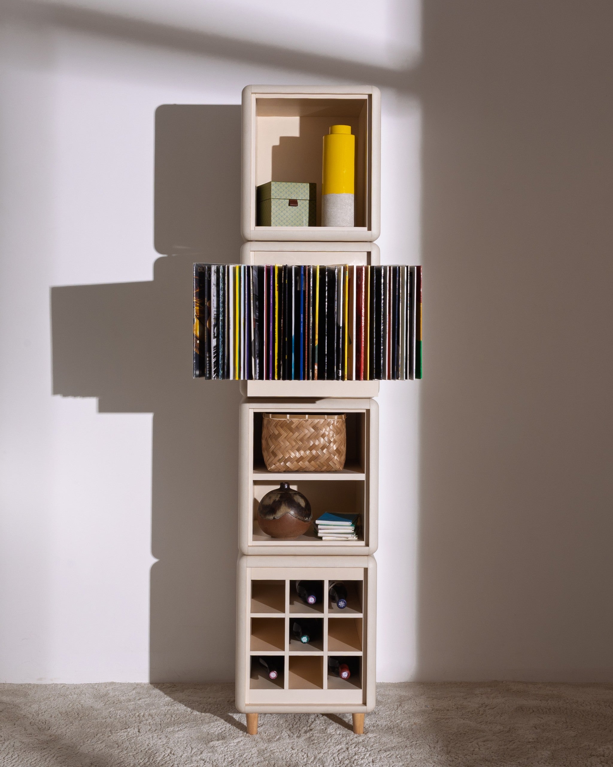 Lou in White Pearl: a tall four-module tower, records fanned in Bloom and bottles in the Grid below — Groovaly