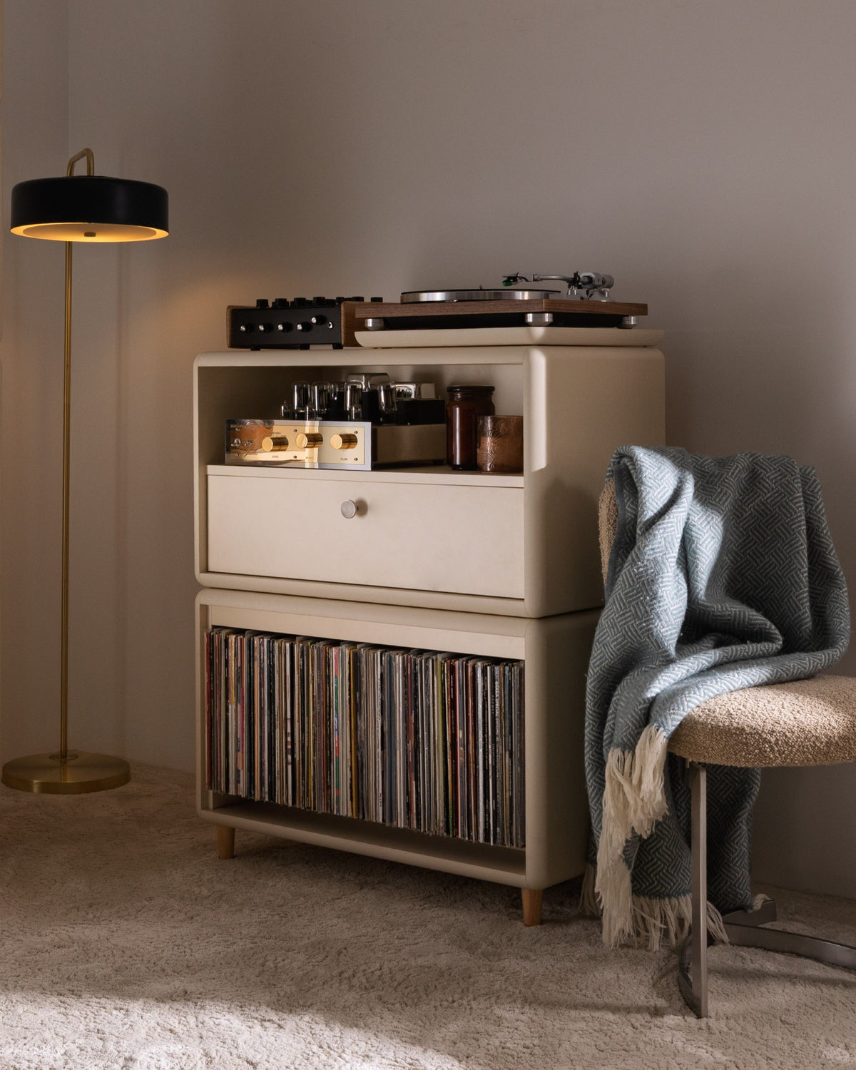 Maceo in White Pearl in a living room, turntable and amp on top, records below, beside a floor lamp — Groovaly