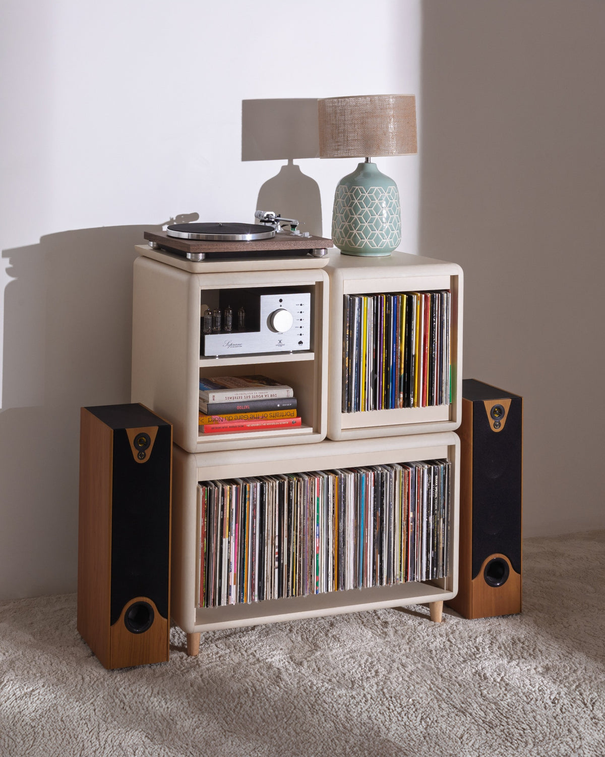 Patti in White Pearl in a room, full of records with a turntable and lamp on top — Groovaly