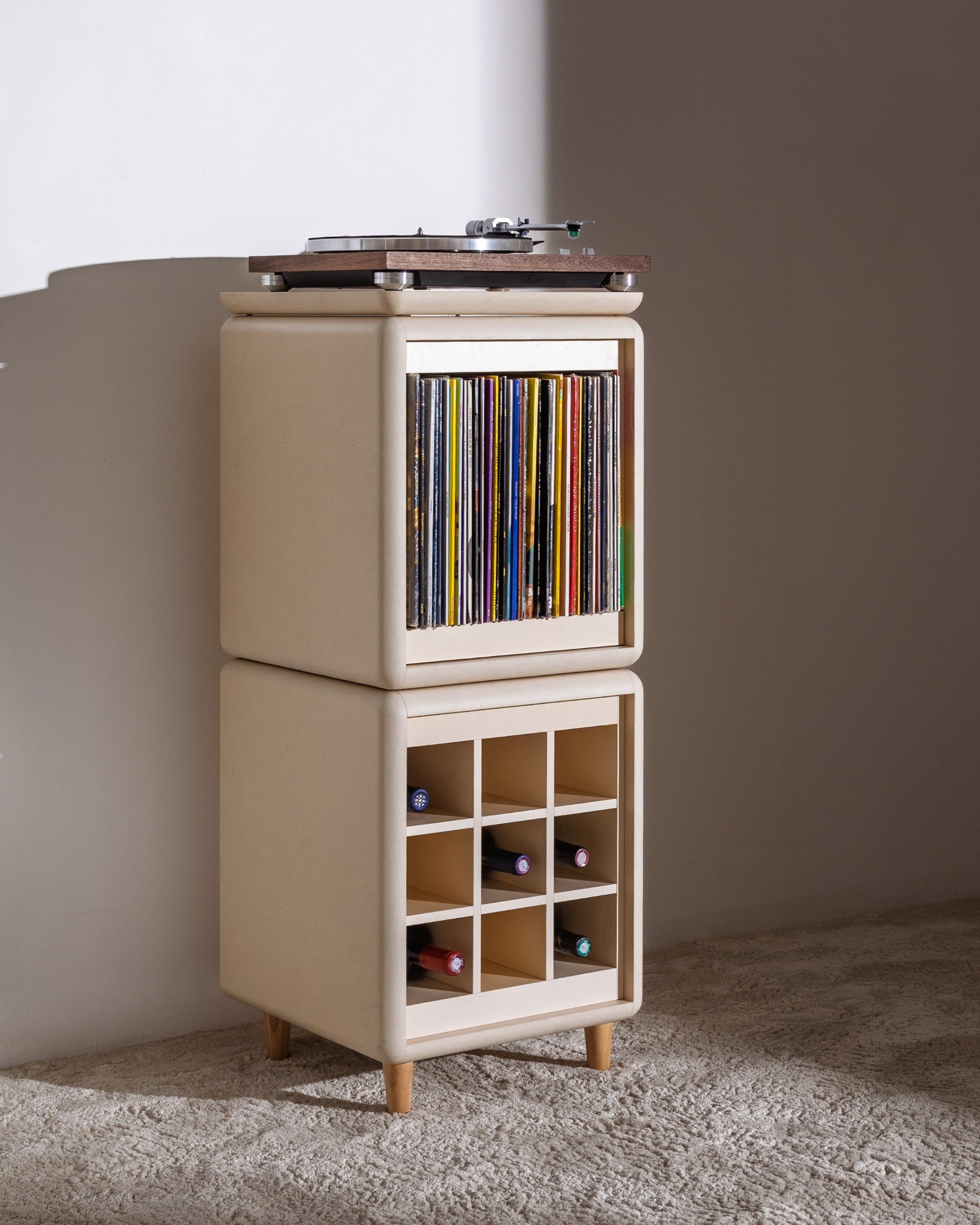 Sly in White Pearl in a room, the Bloom drawer closed, records inside and bottles in the Grid below — Groovaly