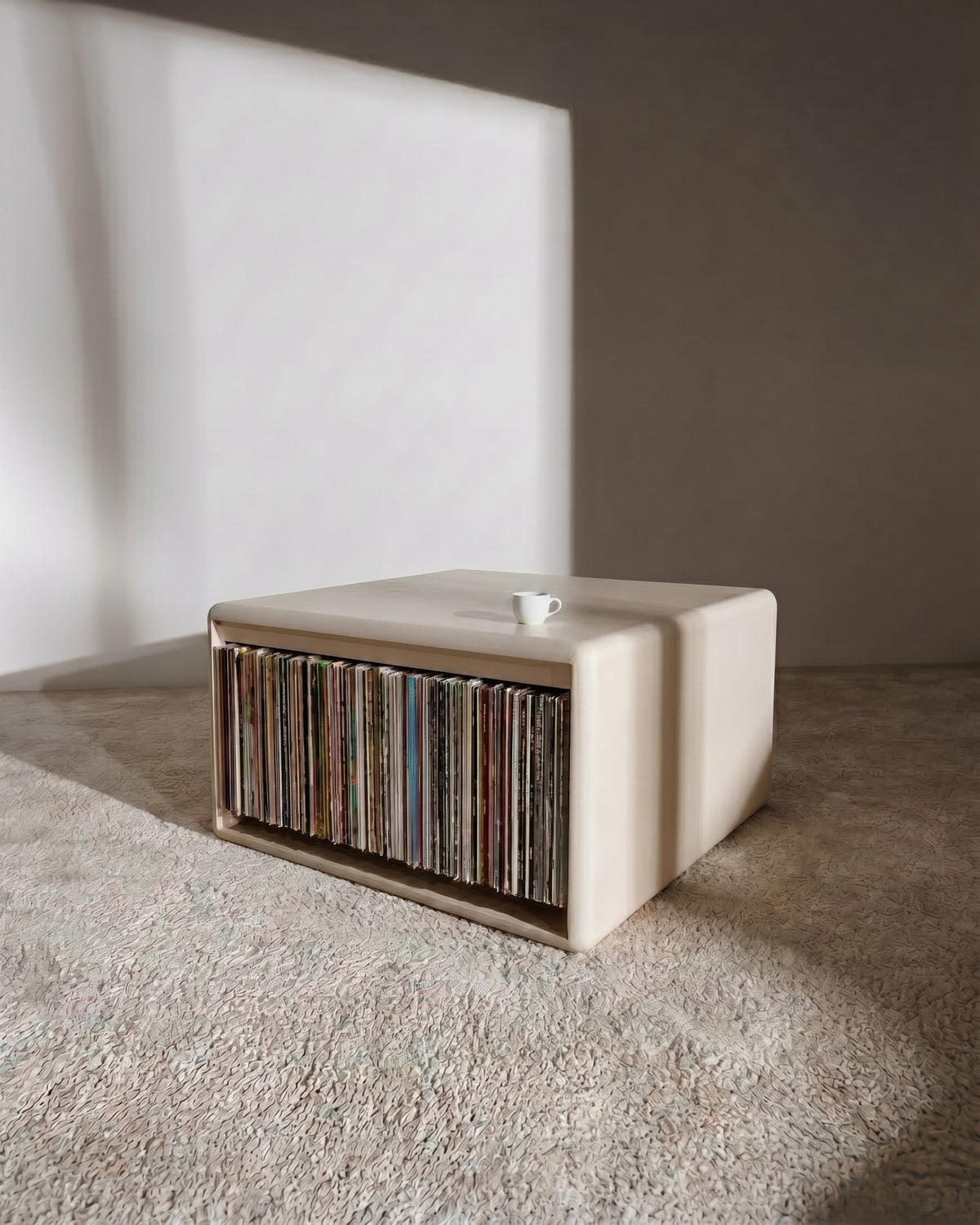 Thelonious vinyl furniture in White Pearl, records on the Tilt side, back-to-back with the Chest, used as a low table — Groovaly