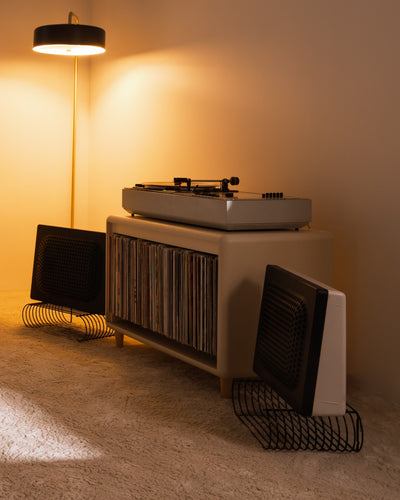Alton in White Pearl in a warm-lit room, turntable on top and records inside, beside a floor lamp — Groovaly