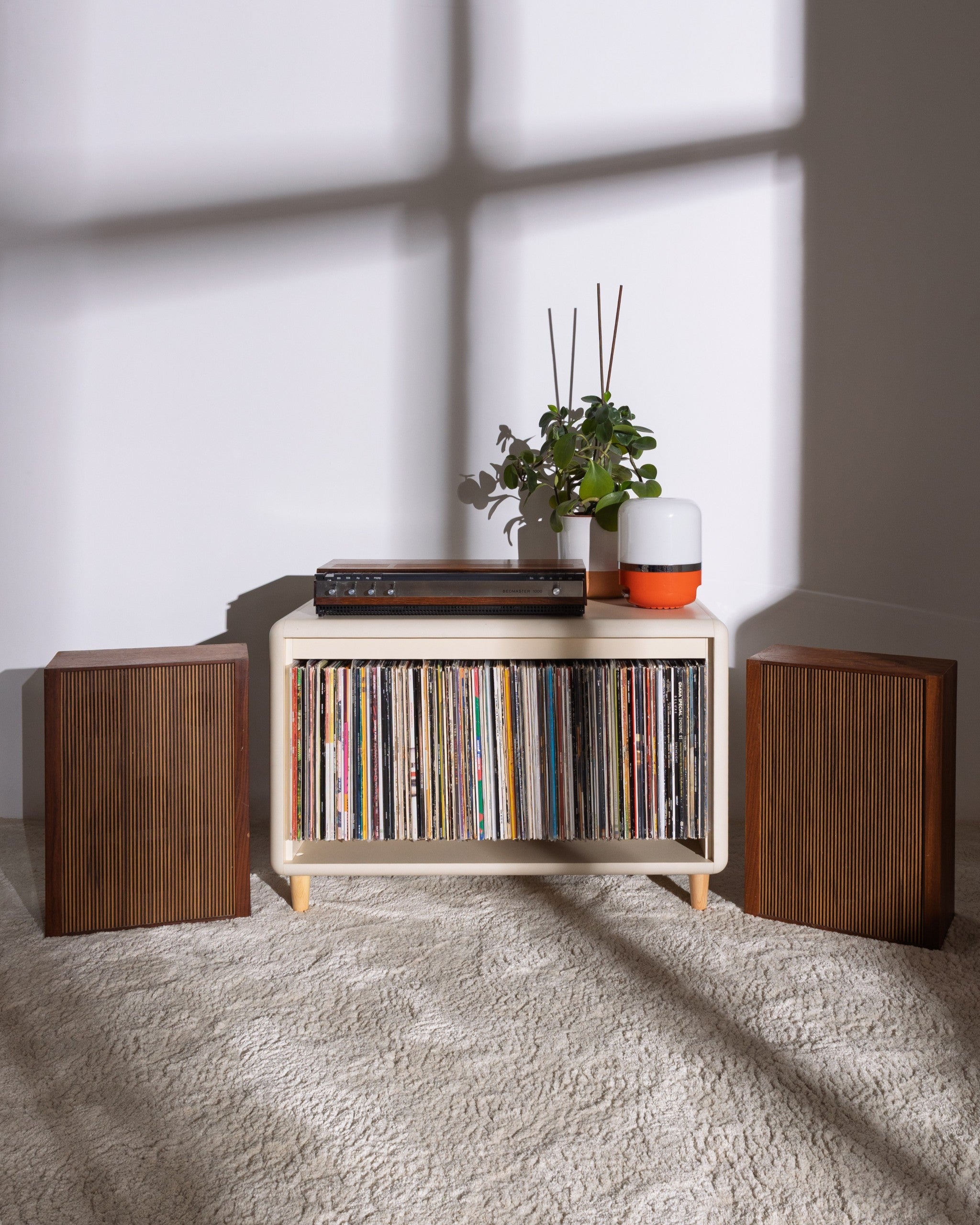 Alton in White Pearl styled with records inside and objects on top, in a room with soft shadows — Groovaly