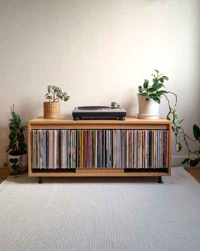 Bloom Console in a Corbridge oak finish in a living room, full of records with a turntable on top — Groovaly