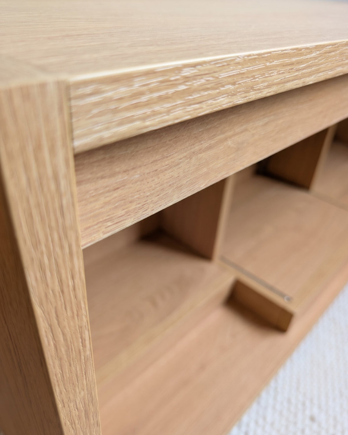 Close view of a Bloom Console bay in a Corbridge oak finish, showing the raised base that holds records clear — Groovaly