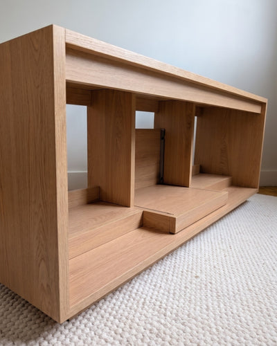Empty Bloom Console in a Corbridge oak finish at a three-quarter angle, showing central compartment and bays — Groovaly