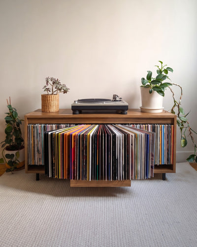 A single Bloom Console with a walnut finish, records fanned open in the Bloom drawer, turntable on top — Groovaly