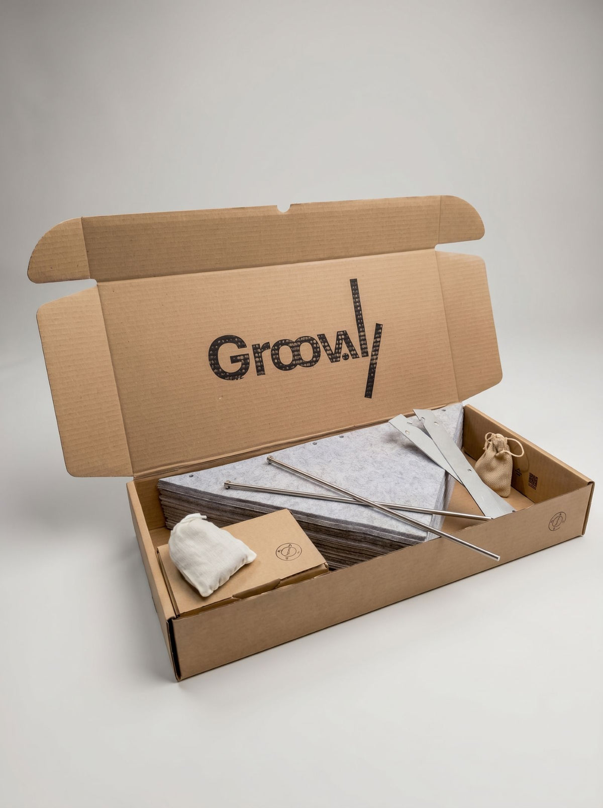 The Bloom Integration Kit in its box: steel rods, side plates, felt sleeves and fittings — Groovaly