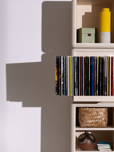 A Bloom fan-drawer open with records fanned out, built into Lou — Groovaly