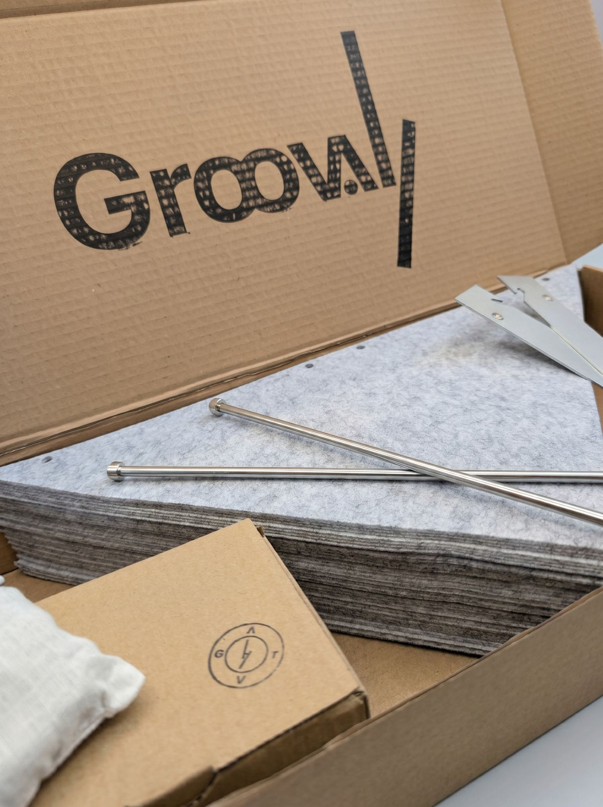 The Bloom Integration Kit packed in its box: grey felt sleeves, steel rods and fittings — Groovaly