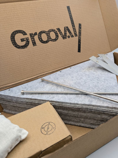 The Bloom Integration Kit packed in its box: grey felt sleeves, steel rods and fittings — Groovaly