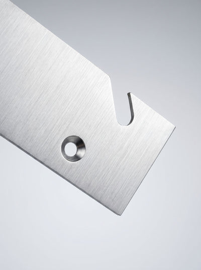 Close-up of a steel side plate from the Bloom Integration Kit, showing the slot and fixing hole — Groovaly