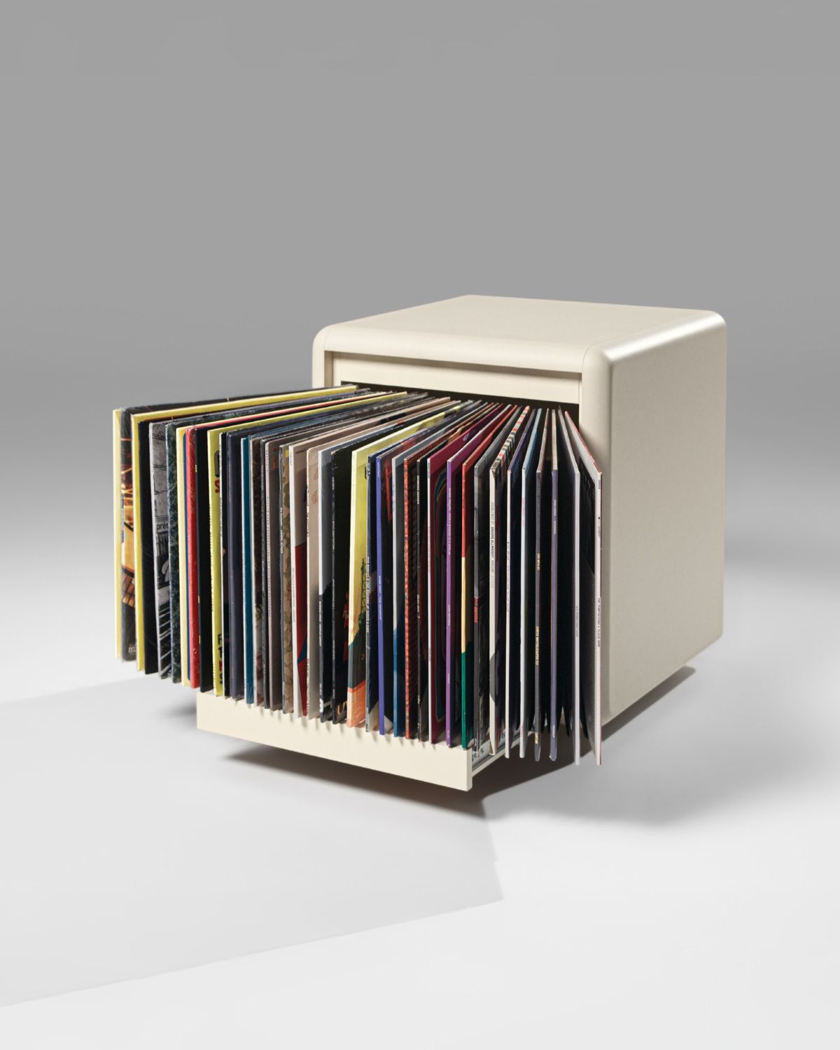 Bloom vinyl module in White Pearl, three-quarter view, drawer open, records fanned out to show their covers — Groovaly