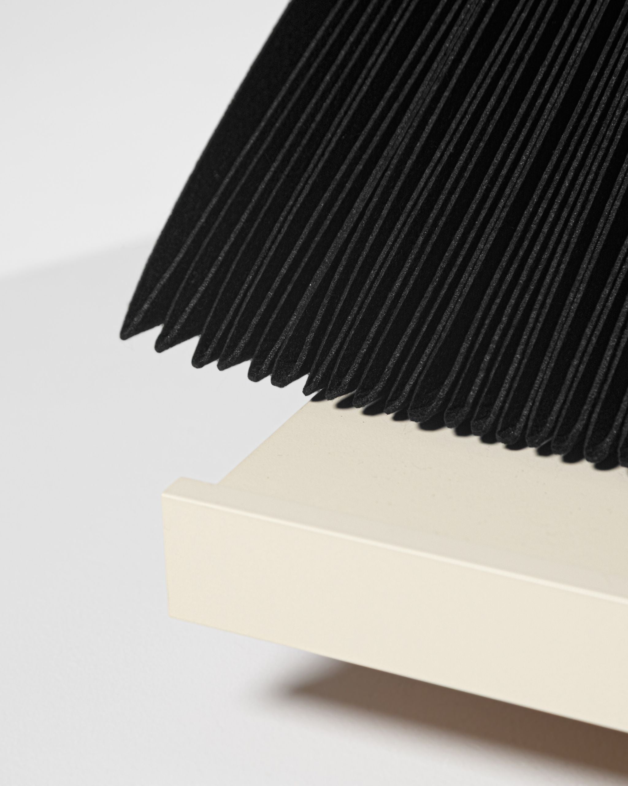 Close-up of the black felt sleeves fanned open above the White Pearl drawer base — Groovaly