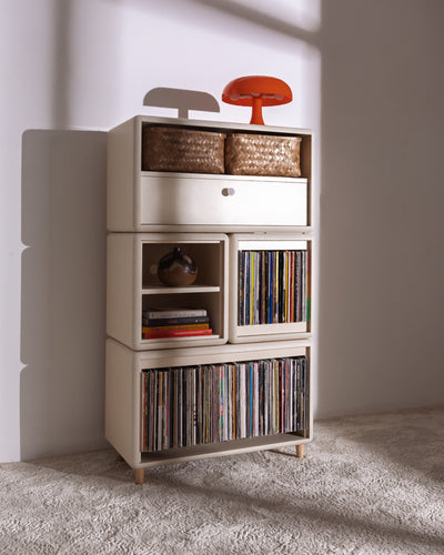 James in White Pearl in a room, full of records with baskets and a lamp on top, the Bloom drawer closed — Groovaly