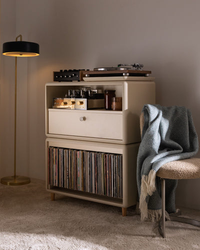 Maceo in White Pearl in a living room, turntable and amp on top, records below, beside a floor lamp — Groovaly