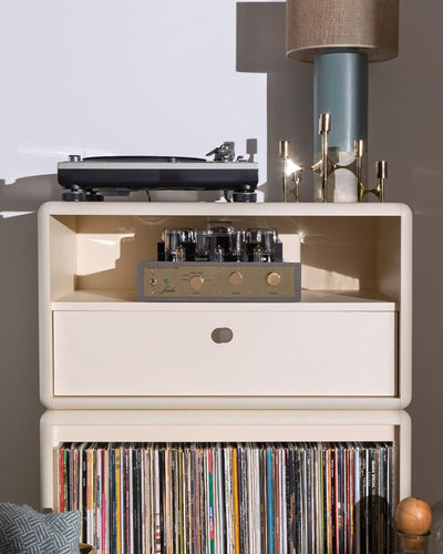 Chest in White Pearl at the top of Maceo, a tube amplifier on its open shelf, records below — Groovaly