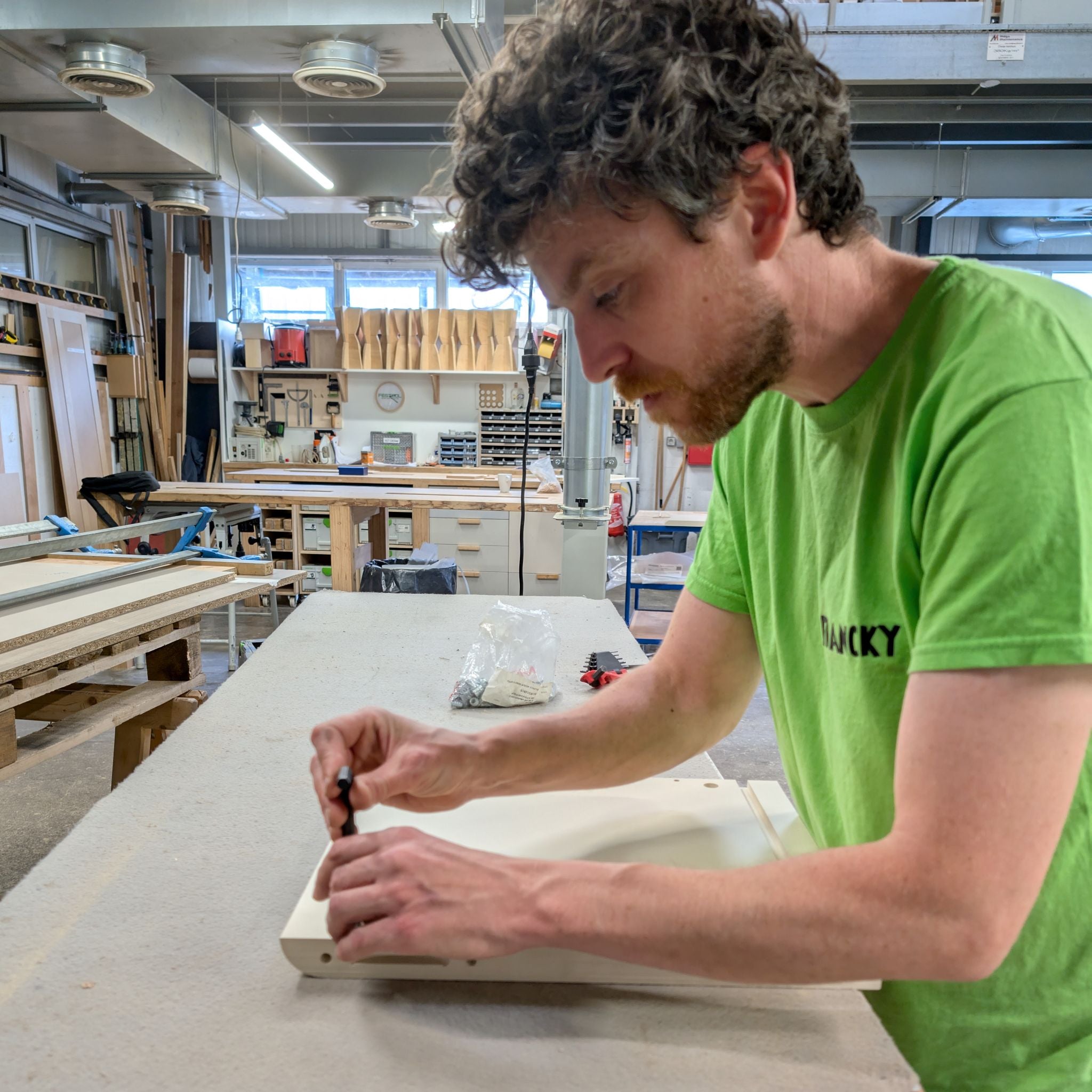 Franck finishing a Golden Age panel by hand in the workshop — Groovaly