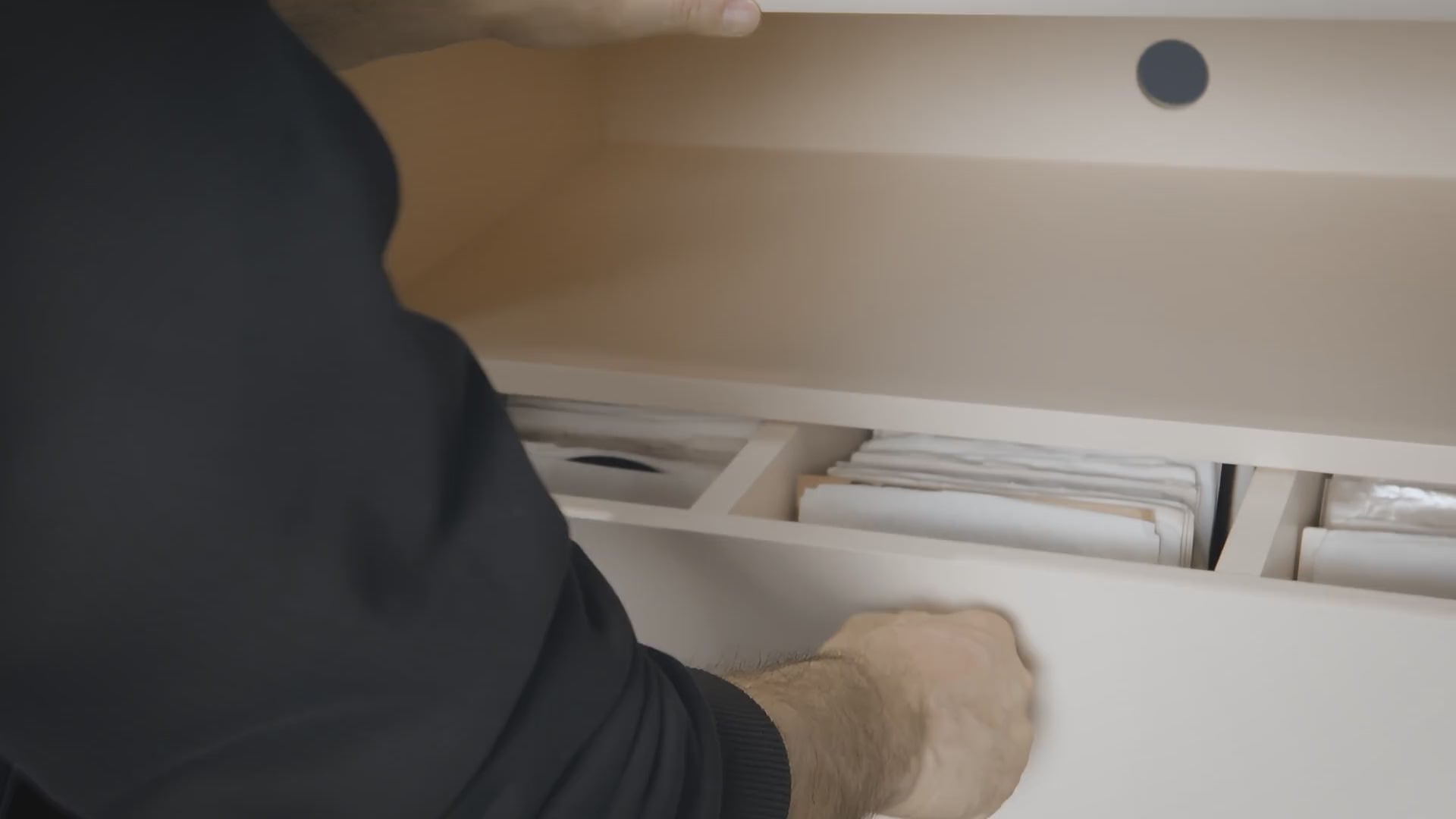 A Chest drawer opened to browse seven-inch singles stored upright, flipped through by their sleeves — Groovaly.