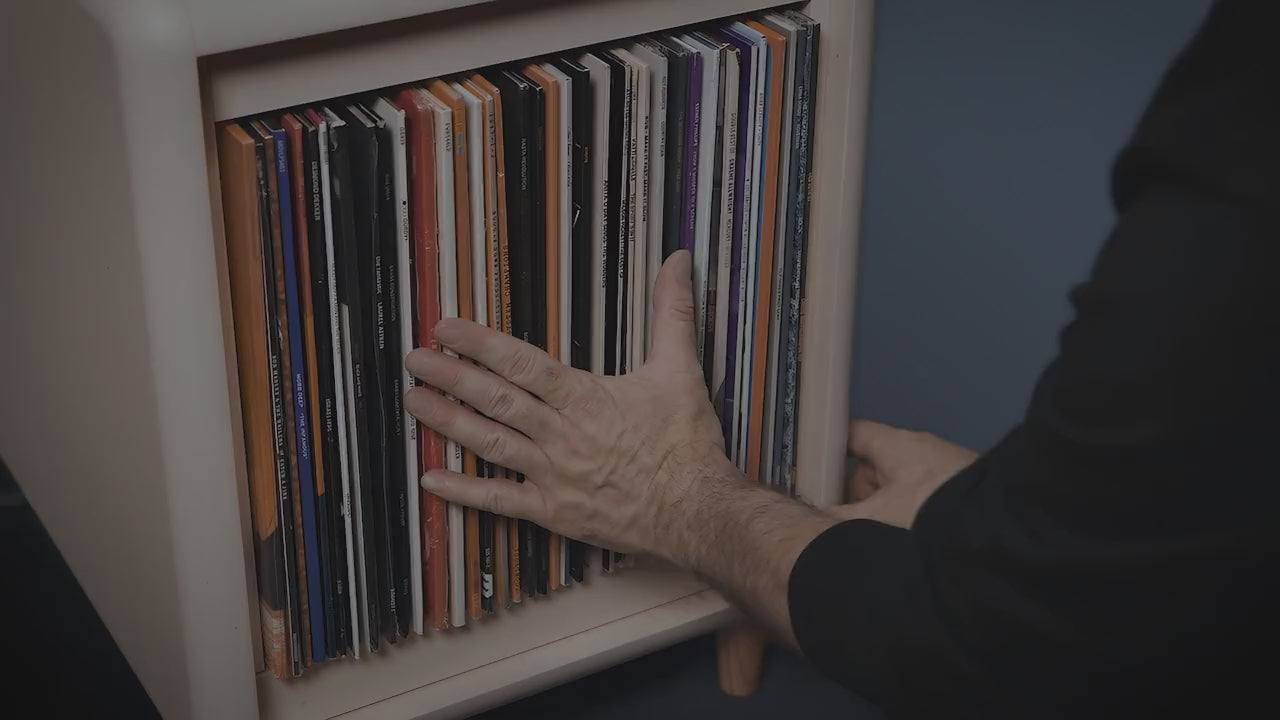Load video: Browsing a record collection in a Bloom Console and Golden Age pieces — covers fanned open, and sleeves tipped forward one by one to read their covers — Groovaly.