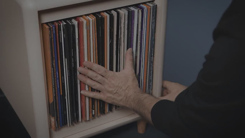 Browsing a record collection in a Bloom Console and Golden Age pieces — covers fanned open, and sleeves tipped forward one by one to read their covers — Groovaly.
