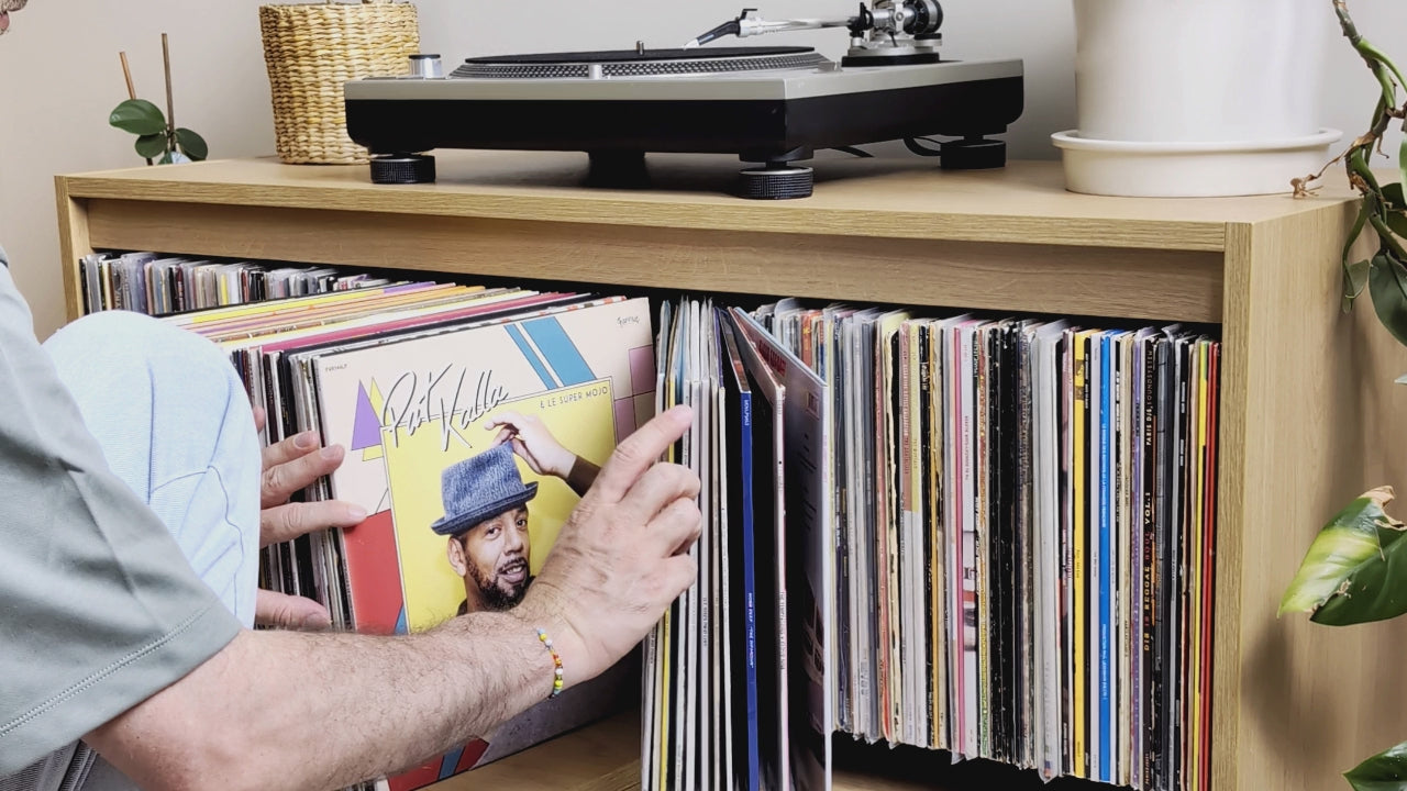 Browsing a Bloom Console — covers fanned open in the central drawer, then a sleeve tipped forward in a side bay and lifted out — Groovaly.
