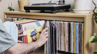 Browsing a Bloom Console — covers fanned open in the central drawer, then a sleeve tipped forward in a side bay and lifted out — Groovaly.