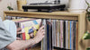 Browsing a Bloom Console — covers fanned open in the central drawer, then a sleeve tipped forward in a side bay and lifted out — Groovaly.