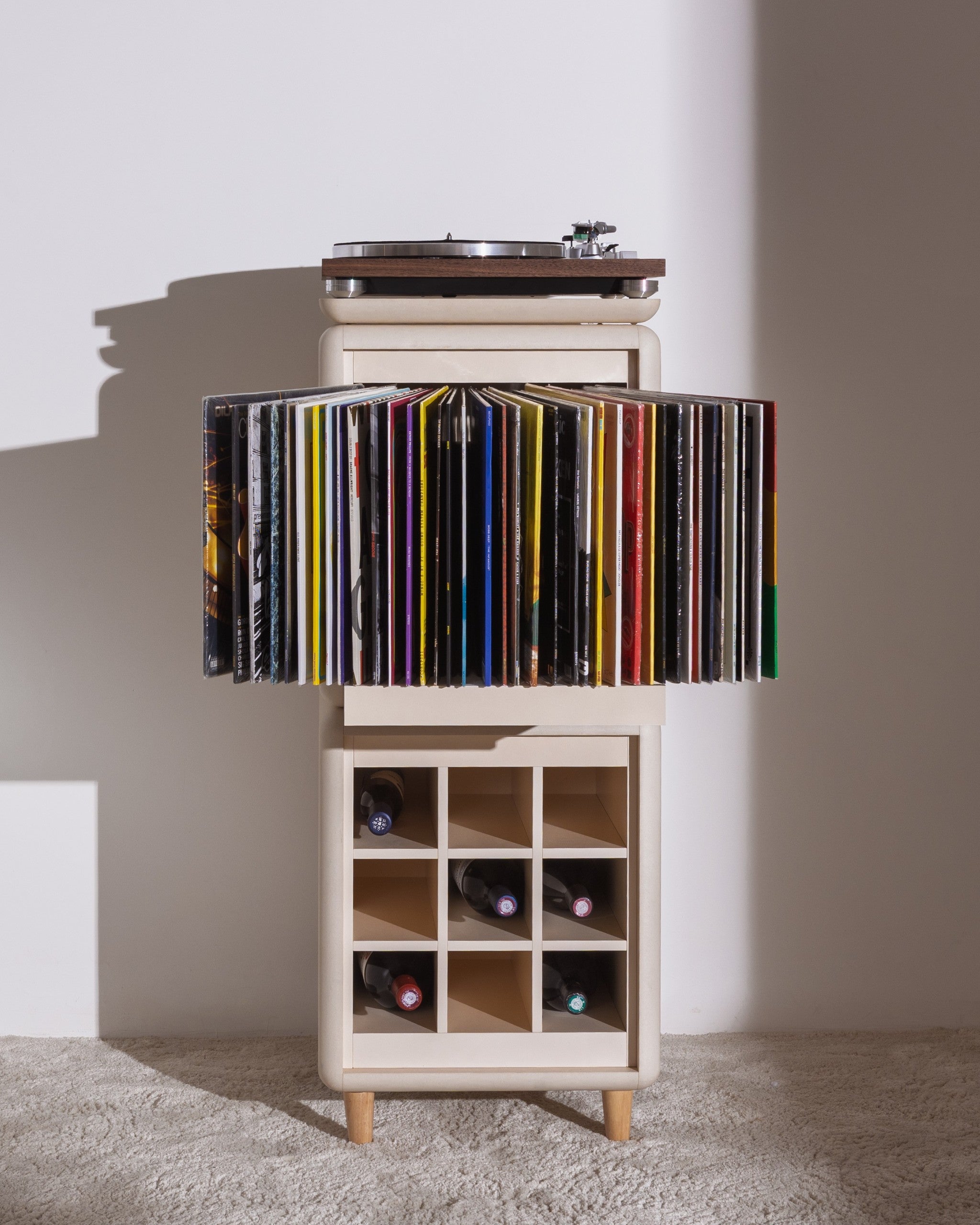 Sly in White Pearl, records fanned in the Bloom drawer, turntable on top and bottles in the Grid below — Groovaly