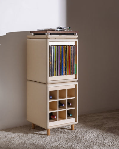 Sly in White Pearl in a room, the Bloom drawer closed, records inside and bottles in the Grid below — Groovaly