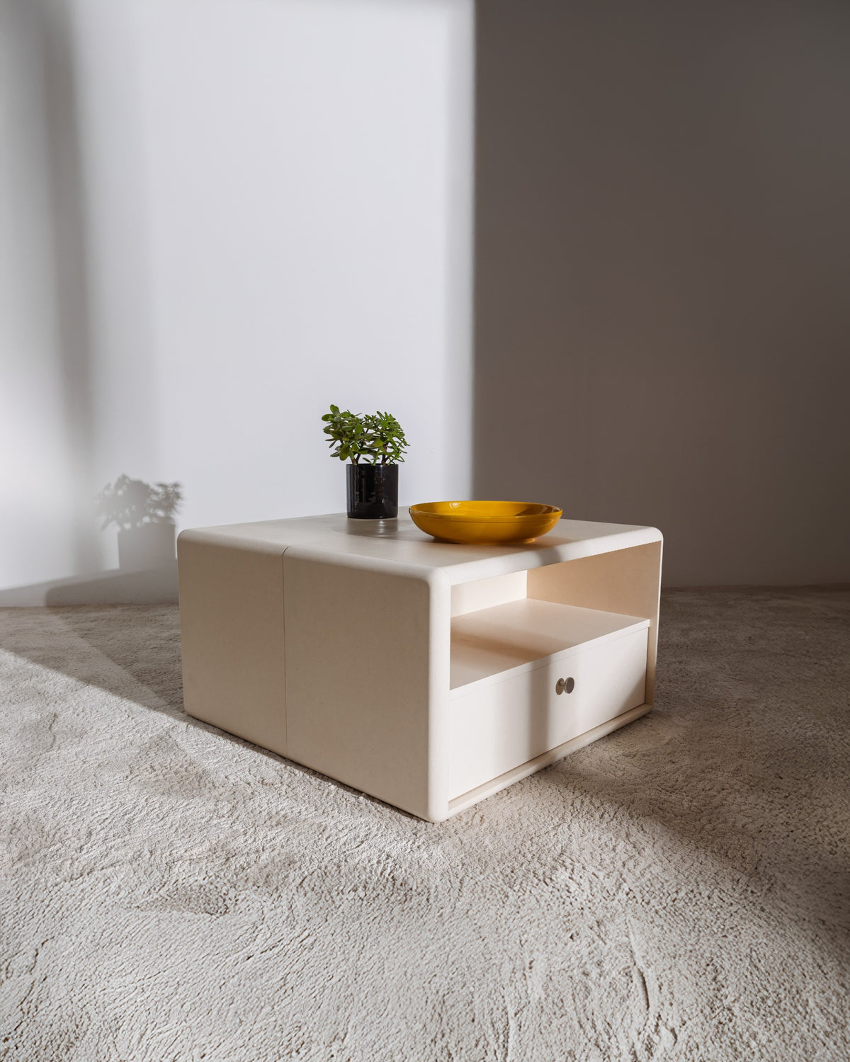 Thelonious vinyl furniture in White Pearl used as a low table, the Chest side with an open compartment — Groovaly