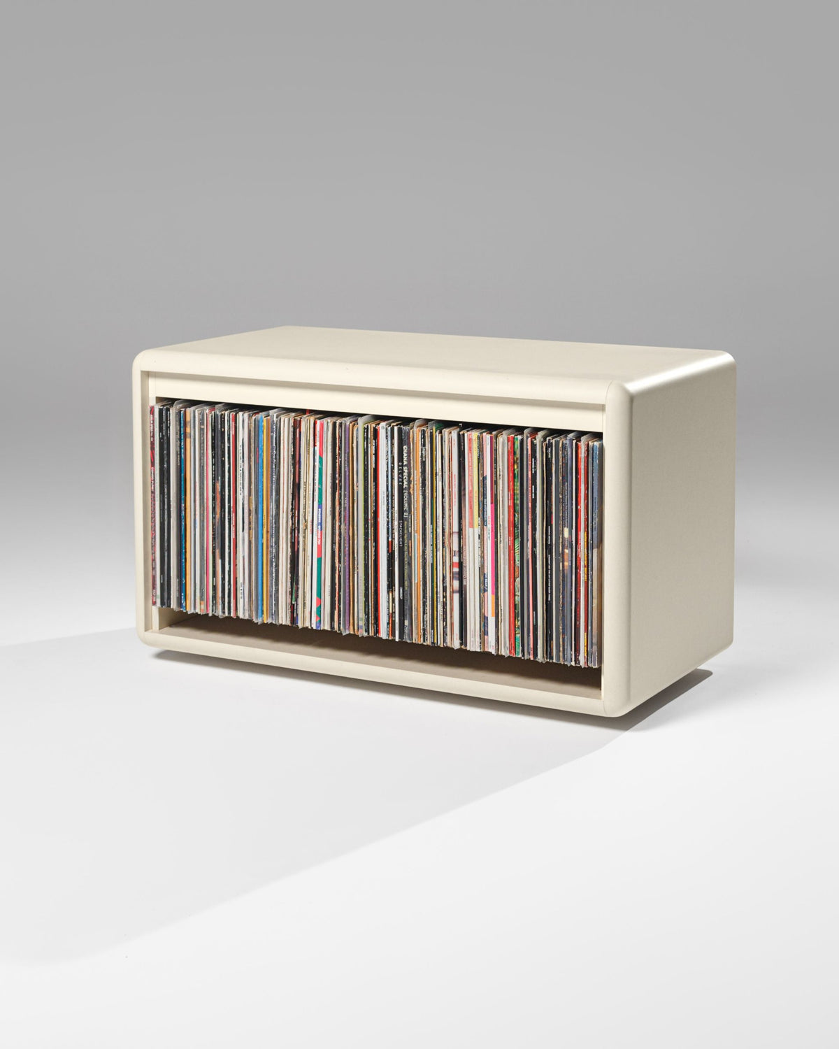Tilt wide vinyl module in White Pearl, three-quarter view, filled with records — Groovaly