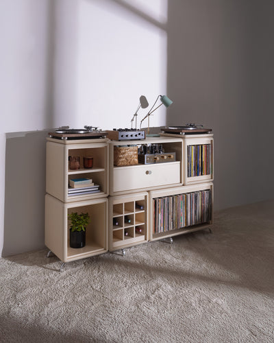 Wilson in White Pearl in a room, full of records with a turntable on top and bottles in the Grid — Groovaly